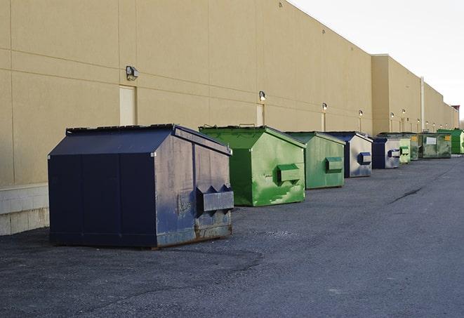 a crowd of dumpsters of all colors and sizes at a construction site in Cherry Creek